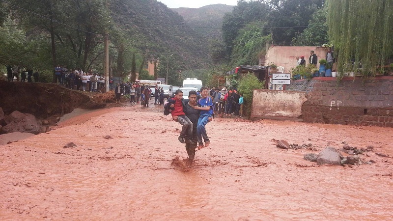 صور معبرة.. شباب يعبرون بالتلاميذ سيلا مائيا جارفا خوفا على حياتهم بمنطقة أولماس